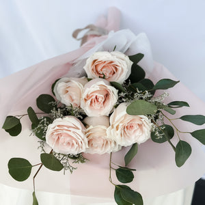 6 roses with dollar tree eucalyptus wrapped in a luxury soft pink paper