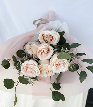 6 roses with dollar tree eucalyptus wrapped in a luxury soft pink paper