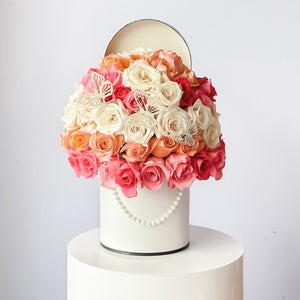 50 roses arrangment placed in a tall hat box with french style