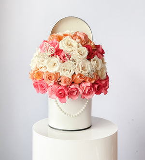 50 roses arrangment placed in a tall hat box with french style