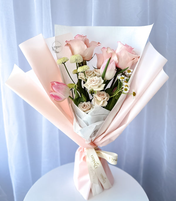 A collection of beautifully arranged floral bouquets with pink and white flowers, wrapped in matching pink and white paper.