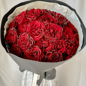 24 red heart big head roses wrapped in black elegance paper