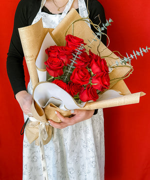 beautiful wrapped 12 freedom roses with eucalyptus and curly willow