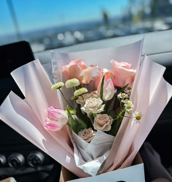 A collection of beautifully arranged floral bouquets with pink and white flowers, wrapped in matching pink and white paper.