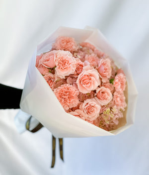 masterfully wrapped in a round shape pink bouquet