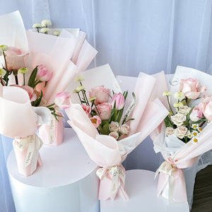A collection of beautifully arranged floral bouquets with pink and white flowers, wrapped in matching pink and white paper.